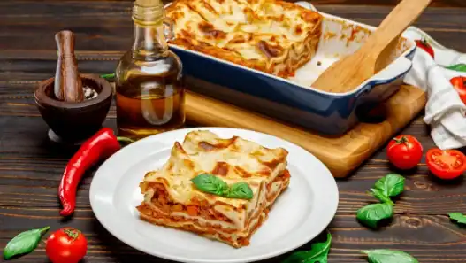 Italian restaurant in Calgary serving a close-up slice of traditional lasagna.