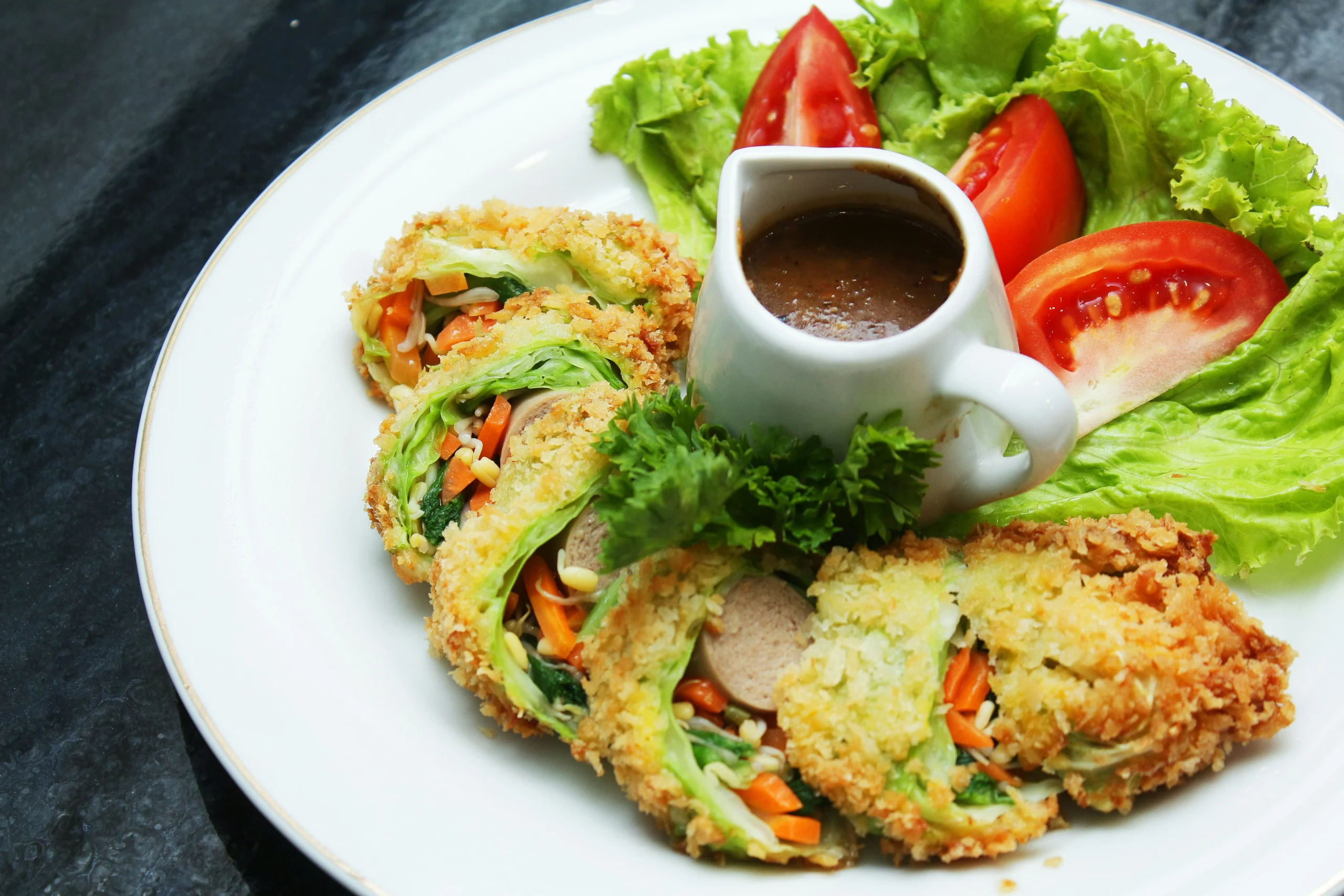 Colorful plant-based dish with crispy rolls and salad served at a top Vegetarian Restaurant in Toronto.
