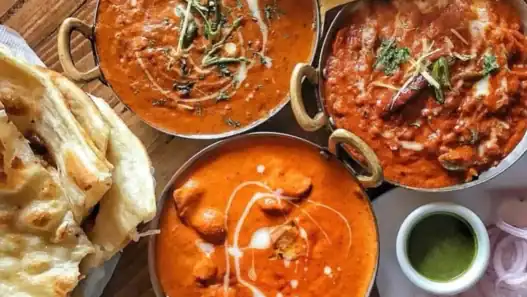 Rich butter chicken, creamy curry, and fresh naan served at a top Indian restaurant in Edmonton