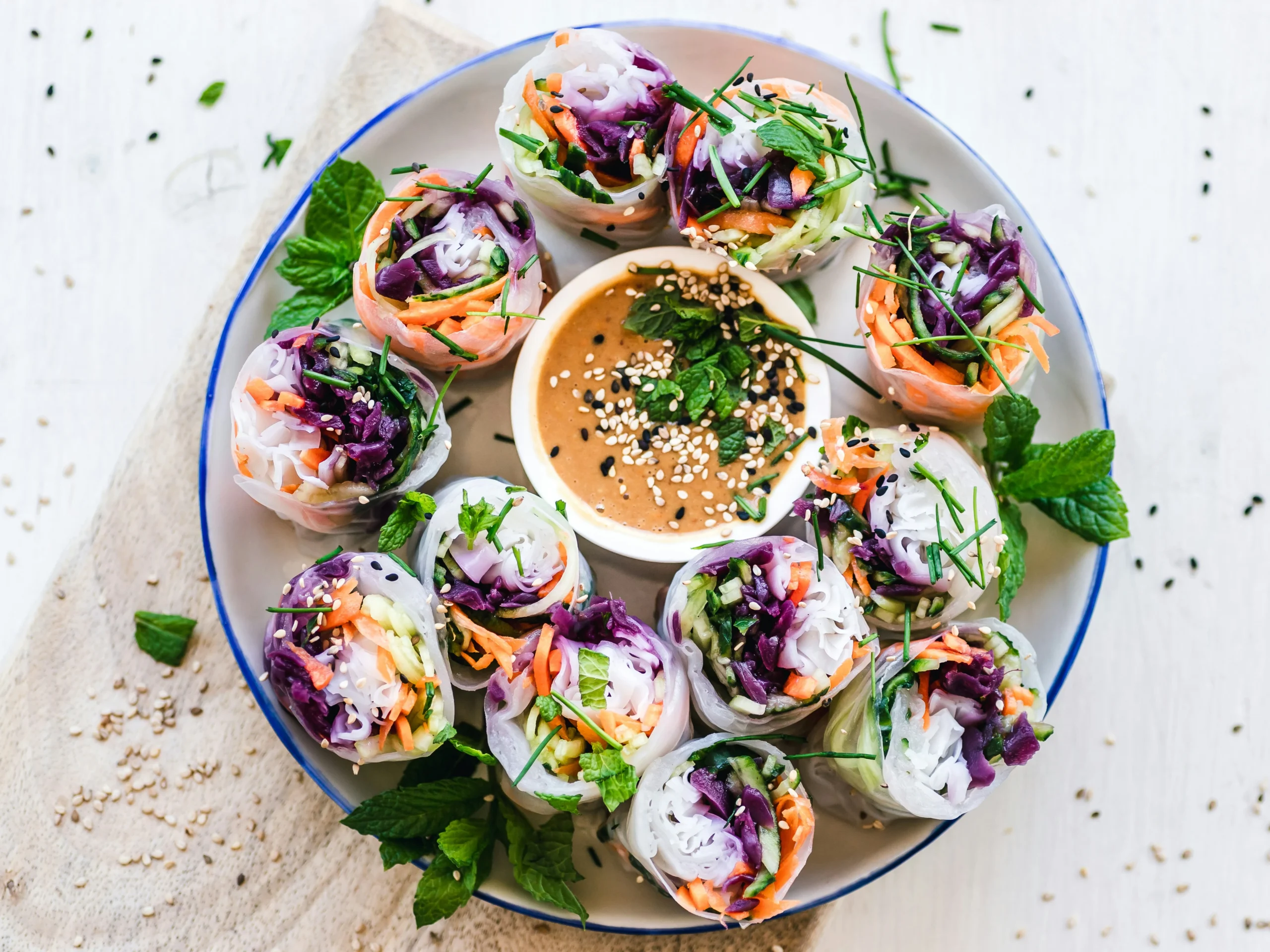 Colorful veggie spring rolls with dip, highlighting fresh vegetarian food in Edmonton.
