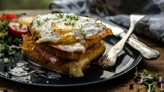 Croque madame served with salad at a French restaurant in Edmonton.