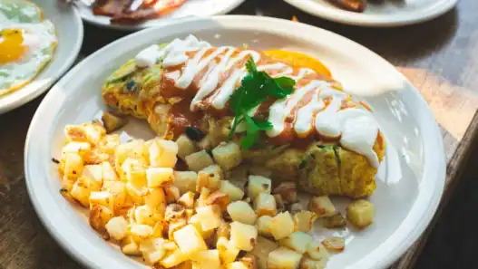 Enjoy a loaded omelet and crispy potatoes at a brunch restaurant in Vancouver.