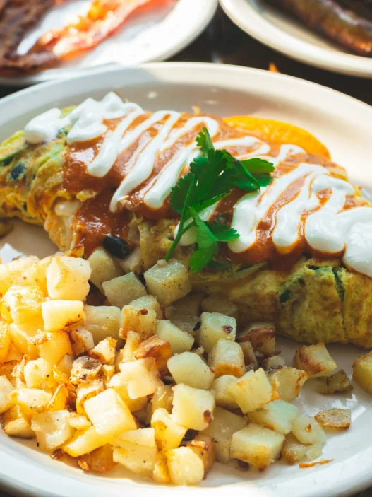 Enjoy a loaded omelet and crispy potatoes at a brunch restaurant in Vancouver.