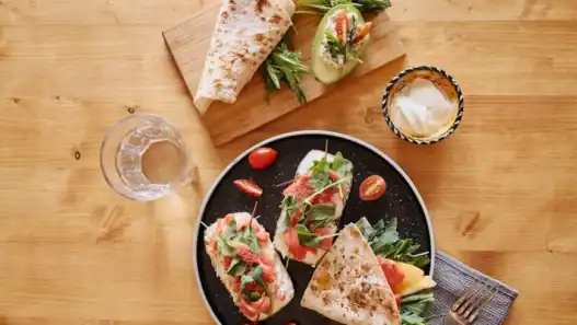 Fresh vegan wraps with greens and tomatoes served in a cozy setting, capturing the vibrant flavors of vegan restaurants in Montreal.