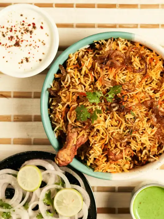Indian restaurants in Montreal serve biryani and traditional Indian food with yogurt, chutney, and fresh garnishes.