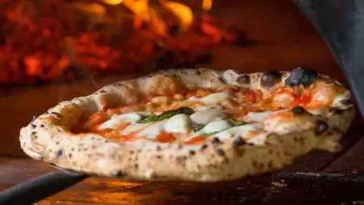 Wood-fired Margherita pizza at a top Italian restaurant in Montreal.
