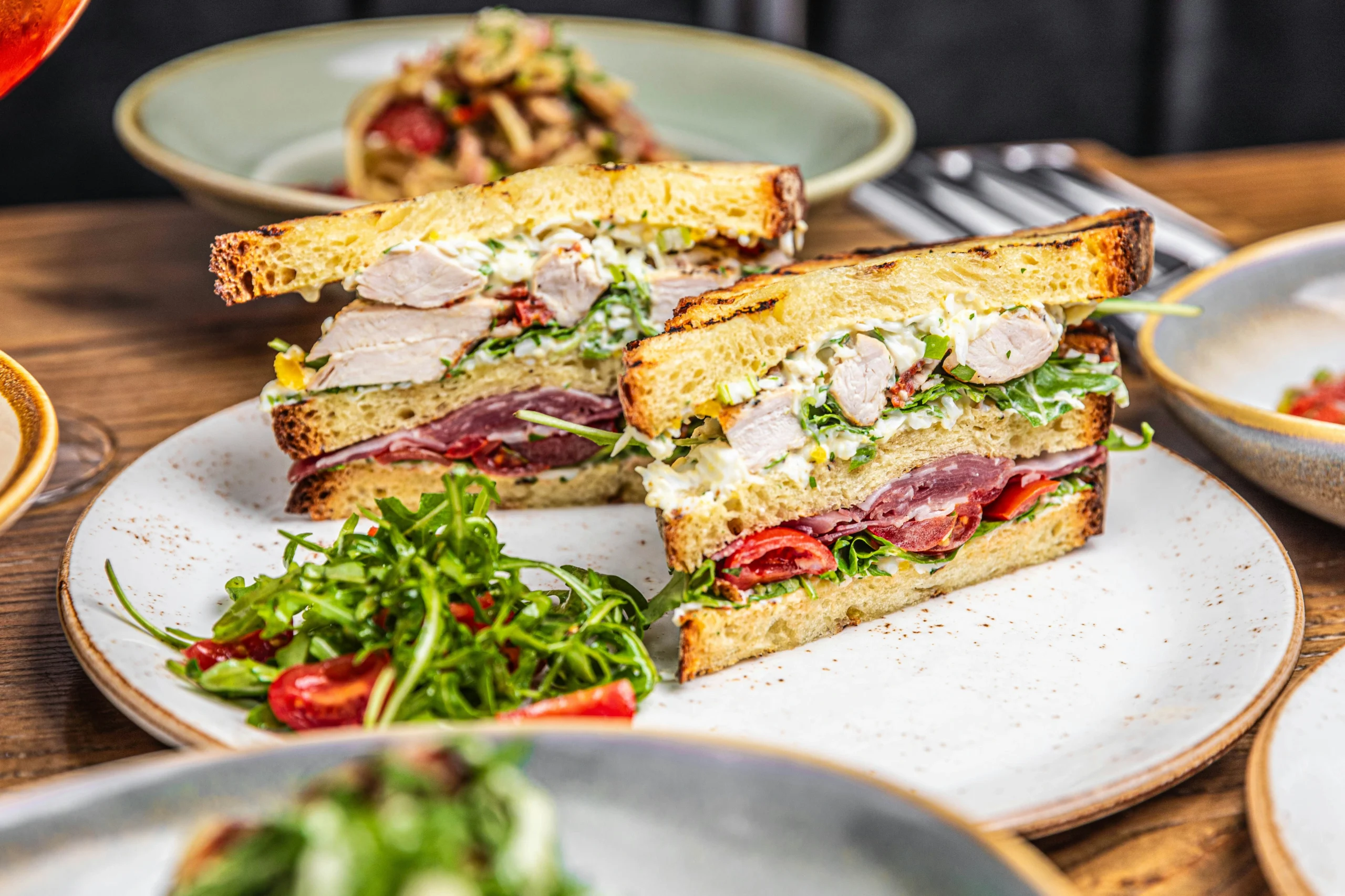 Stacked sandwich perfection at a top brunch restaurant in Edmonton, served with fresh greens