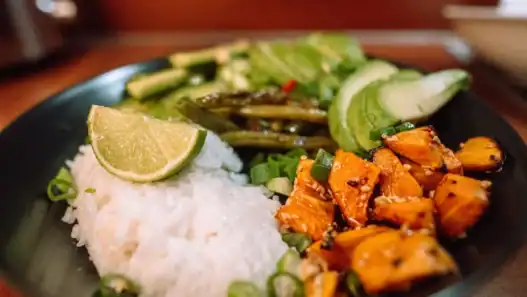 Vegan rice bowl with roasted vegetables and lime, highlighting fresh plant-based cuisine in Vancouver.